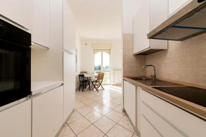 a kitchen with a sink and a counter top at Blue Dreams - Marittima in Marittima