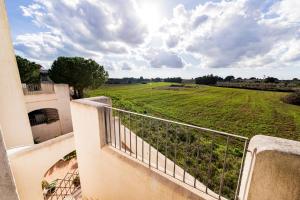 a balcony with a view of a green field at Blue Dreams - Marittima in Marittima