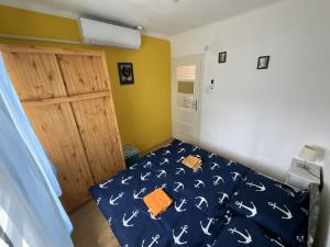 a bedroom with a bed with a blue comforter with d planes at Anna Vendégház in Harkány +2 photos