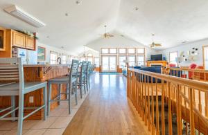 a dining room with a bar and chairs at Dune Diamond - Nags Head MP 16.5, Oceanfront, Elevator, Heated Pool, Hot Tub, Pets OK, Flex Stays in Nags Head