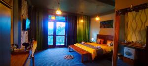 a bedroom with a yellow bed and a window at Ella T&D Resort in Ella