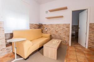a living room with a couch and a table at GuestReady - Calvario Rota 30 JC in Rota