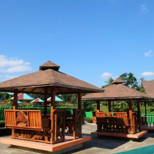 a group of gazebos with chairs and tables at RR Family Spring Resort in Maramag