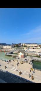 a view of a beach with people in the water at Studio l'écluse in Le Tréport