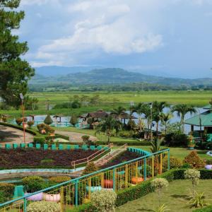 a view of a resort with mountains in the background at RR Family Spring Resort in Maramag