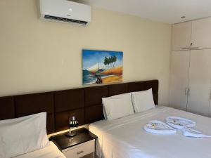 a bedroom with a bed with two towels on it at Vizinho dos Parapente - Novo Luxo apartamento in Canoa Quebrada