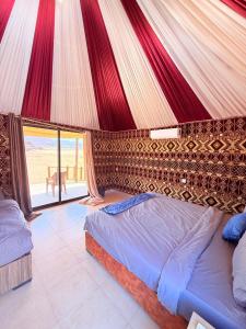 a bedroom with a bed in a tent at Luxury Camp Wadi Rum in Disah