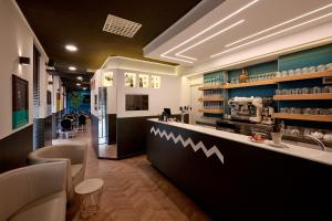 a restaurant with a counter in a room at Hotel & Residence Torino Centro - Stazione Porta Susa in Turin