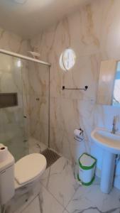 a bathroom with a toilet and a sink at Pousada Maturi - Pipa in Pipa +13 photos