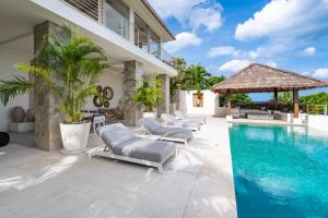 a villa with a swimming pool and lounge chairs at Villa Kohia, stunning sea views, breakfast, serviced daily, private dining service on request, North Chaweng in Nathon Bay