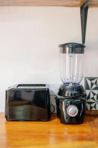 a blender and a toaster oven on a table at Finca Aisa -Boutique bungalows in Ometepe island in Santa Cruz