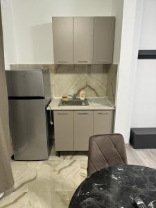 a small kitchen with a sink and a refrigerator at Pollux Residence Militari Ap 81 in Bucharest