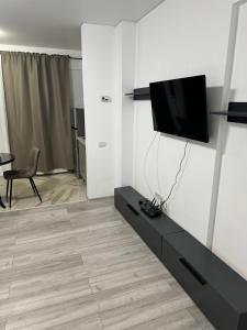a living room with a flat screen tv on a wall at Pollux Residence Militari Ap 81 in Bucharest