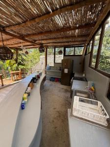 a boat room with couches and tables and windows at La baxada mazunte in Mazunte +13 photos
