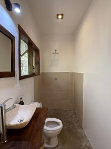 a bathroom with a sink and a toilet at La baxada mazunte in Mazunte