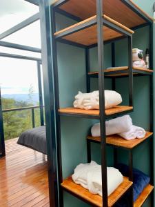 a room with a shelf with towels on it at Kamarí Glamping in San Francisco +34 photos
