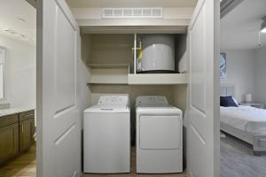 two washing machines in a room with a bed at Chisholm Trace 1236 I Spacious 1 Bed 1 Bath in Cleburne +25 photos