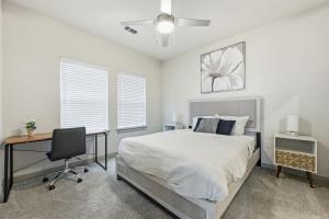 a bedroom with a bed and a desk and a chair at Unit 232 Comfy 2BR 2BA Retreat in Cleburne +26 photos