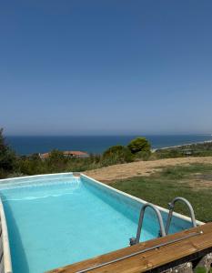 a swimming pool with the ocean in the background at B&B Sunset da carla in Agropoli