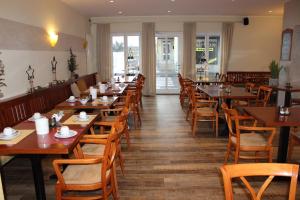 a dining room with wooden tables and chairs at Hotel Bitburger Hof in Bitburg