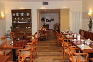 a dining room with wooden tables and chairs at Hotel Bitburger Hof in Bitburg
