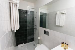 a bathroom with a shower with a toilet and a sink at Oporto City View - Santa Catarina in Porto