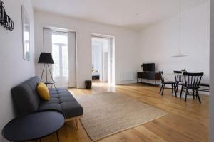 a living room with a couch and a dining room at Oporto City View - Santa Catarina in Porto