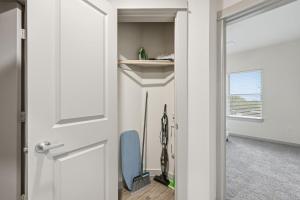 a hallway with a door and a blue chair at Chisholm Trace 812 Perfect 2BD 2BA in Cleburne +25 photos