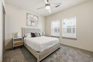 a bedroom with a bed and a ceiling fan at Chisholm Trace 327 Relaxing 2BD 2BA in Cleburne +25 photos