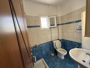 a bathroom with a toilet and a sink at Villa Mickey in Hanioti +19 photos