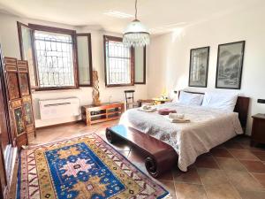 a bedroom with a large bed and a rug at Villa Rita - Rooms&Art in Case Ghisiolo