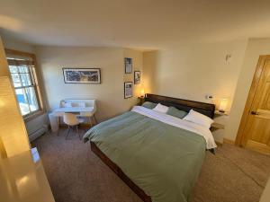 a bedroom with a large bed and a desk at Family Ski Getaway in Kirkwood