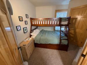 a small bedroom with two bunk beds and a door at Family Ski Getaway in Kirkwood +20 photos
