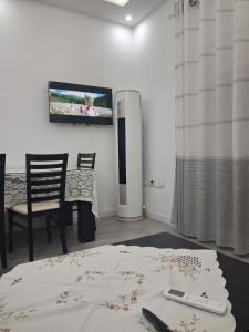 a living room with a television on a wall at Jurgen House in Piskupat