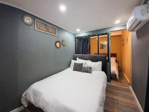 a bedroom with a large white bed in it at Le Jacuzzi Room in Perpignan