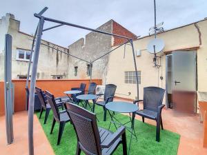 a group of tables and chairs on a patio at Le Jacuzzi Room in Perpignan