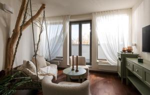 a living room with two chairs and a swing at HERBARIUM boutique hotel in Olomouc