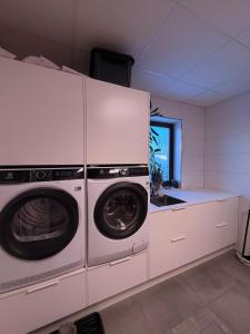 a kitchen with two washing machines and a sink at Lofoten Viewpoint 13 in Vestvågøya