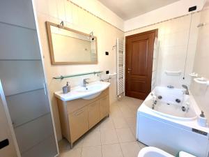 a bathroom with a sink and a toilet and a tub at Villa Rita - Rooms&Art in Case Ghisiolo +37 photos
