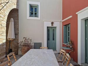 a dining room with a table and chairs at Symi Village House in Symi