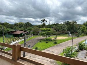 a view of a road from a wooden fence at Casa do Rio in Morretes