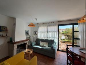 a living room with a couch and a table at Cala Tatina in Celorio