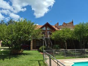 a house with a swimming pool in the yard at Cabañas La Belen in Merlo