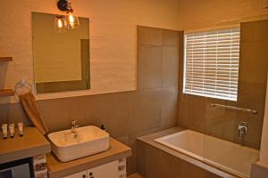 a bathroom with a sink and a bath tub at 1001 Pont de Val in Parys +5 photos