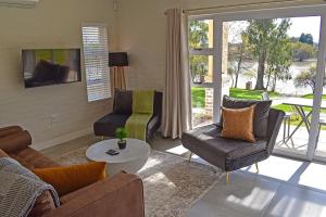 a living room with a couch and chairs and a table at 1001 Pont de Val in Parys