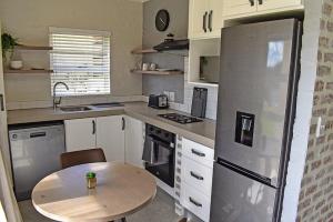 a small kitchen with a table and a refrigerator at 1001 Pont de Val in Parys
