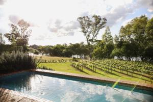 a swimming pool in front of a field with trees at 1001 Pont de Val in Parys