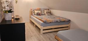 a small bedroom with a bed and a desk at Sielskie Sitno in Sitno