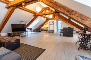 an attic living room with wooden beams at Black Apartment - Large Spacious One Bedroom Penthouse Loft in Baden-Baden