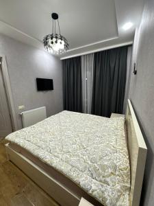 a bedroom with a large bed in a room at Ander Tower in Stantsiya Batumi-Passazhirskaya